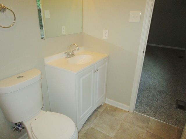 bathroom featuring tile patterned flooring, vanity, and toilet