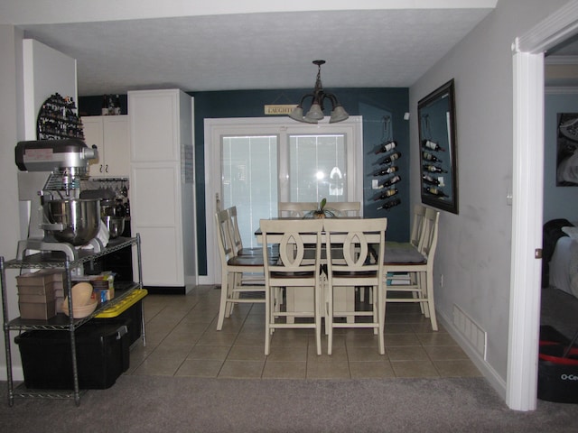 carpeted dining space with a notable chandelier