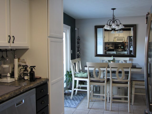 tiled dining space with a chandelier