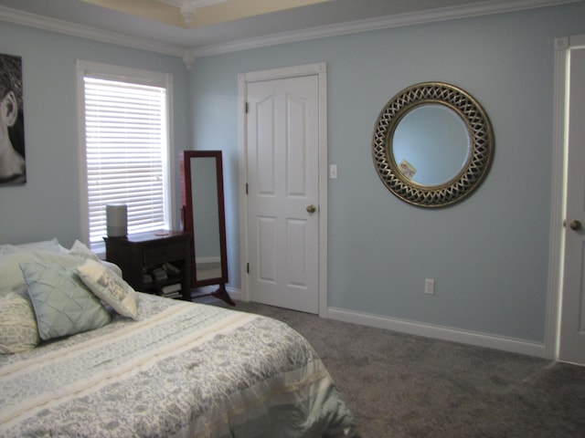 bedroom with crown molding and dark colored carpet