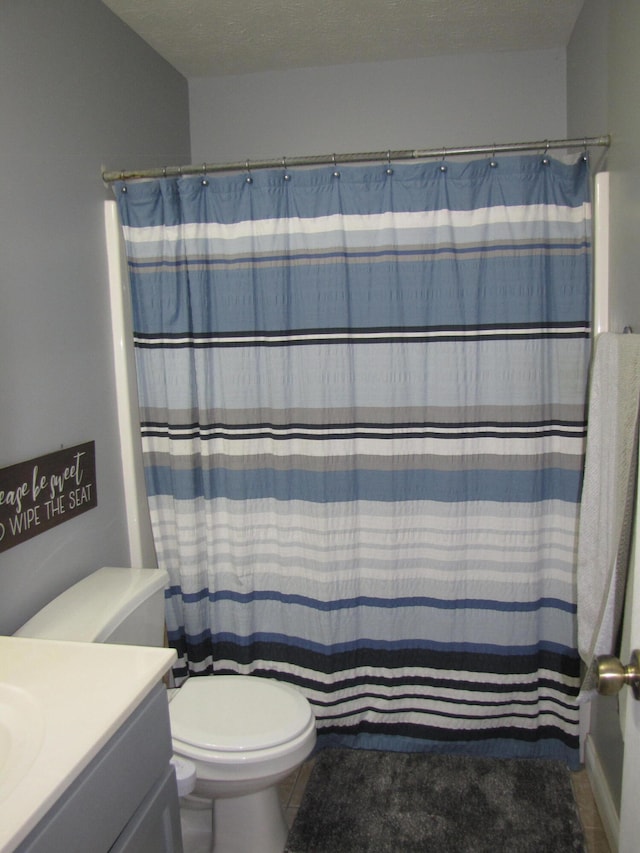 bathroom with toilet, tile patterned floors, a textured ceiling, vanity, and a shower with curtain