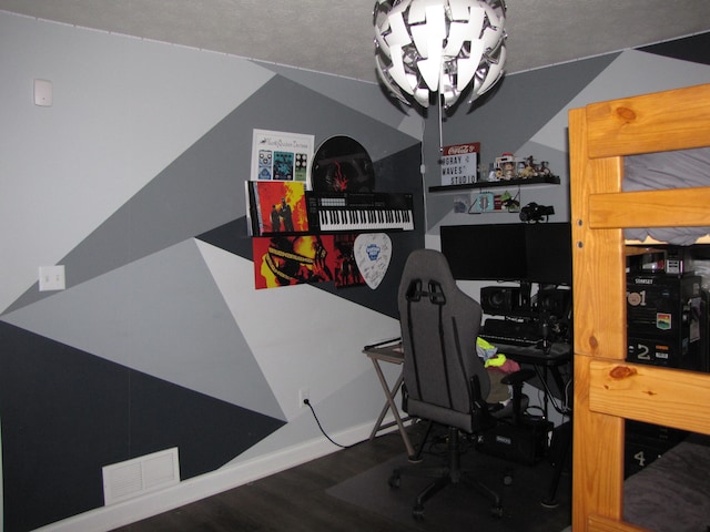 home office with dark hardwood / wood-style flooring and a textured ceiling