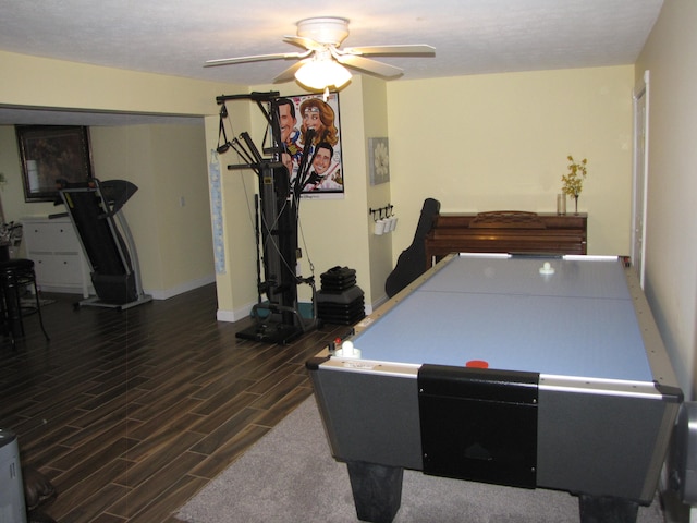 game room featuring dark wood-type flooring and ceiling fan