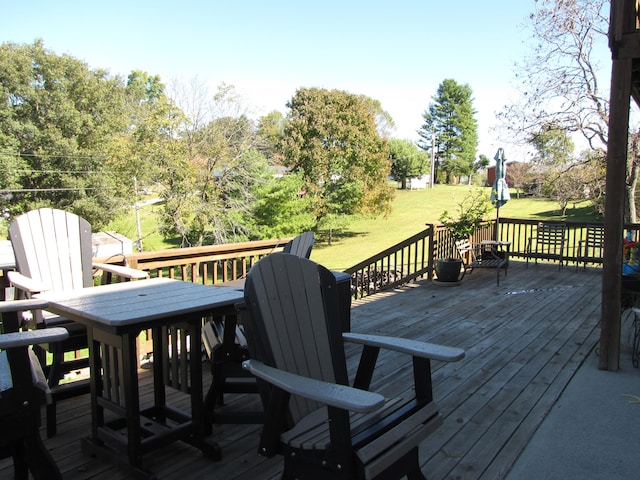 wooden deck featuring a yard