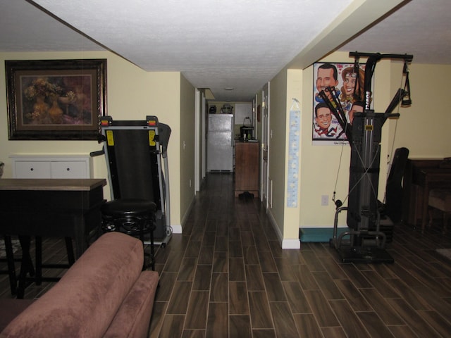 hall featuring dark hardwood / wood-style floors and a textured ceiling