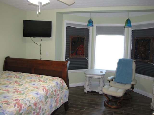 bedroom featuring ceiling fan and dark wood-type flooring