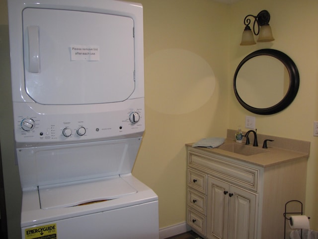 laundry room featuring stacked washing maching and dryer and sink