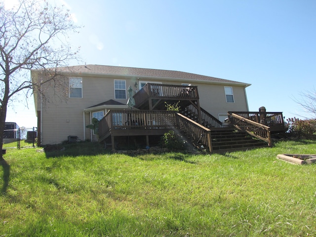 rear view of property with a yard and a wooden deck