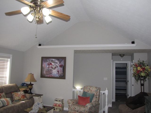 living room with lofted ceiling, ceiling fan, and carpet flooring