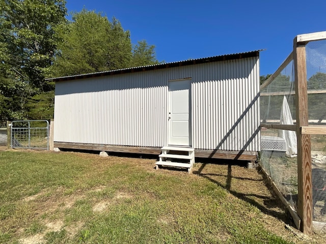 view of side of property featuring a yard and an outdoor structure