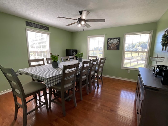 dining space featuring ceiling fan, a textured ceiling, and dark hardwood / wood-style flooring