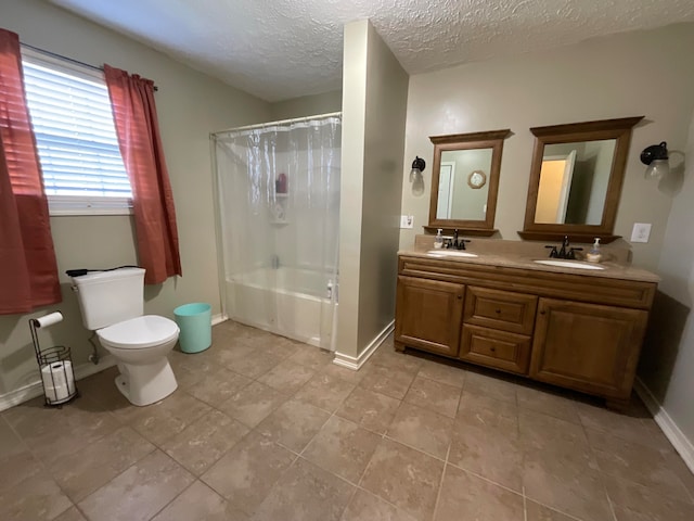 full bathroom featuring vanity, toilet, shower / bath combo, a textured ceiling, and tile patterned flooring