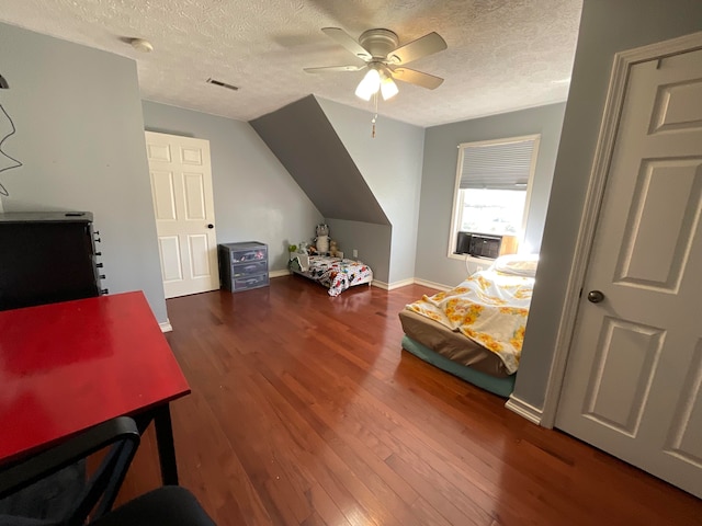 bedroom with a textured ceiling, ceiling fan, vaulted ceiling, and dark hardwood / wood-style flooring