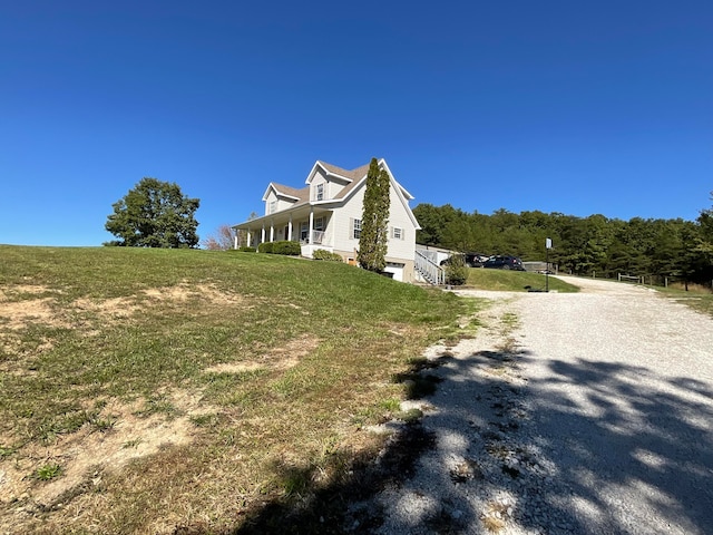 view of side of home featuring a lawn