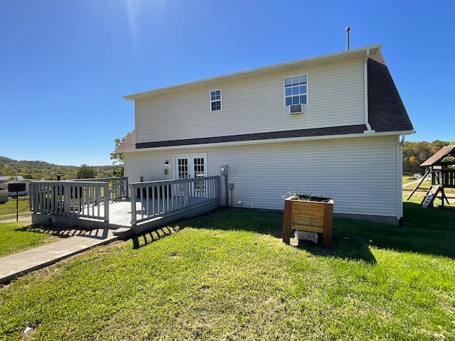 back of property with cooling unit, a yard, and a deck