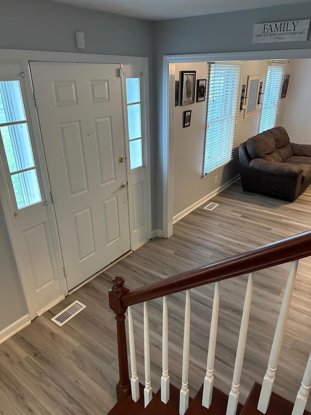 foyer entrance with hardwood / wood-style floors