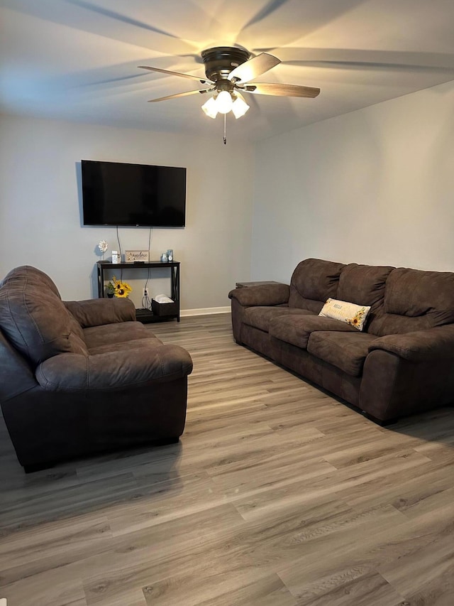 living room featuring light wood-type flooring and ceiling fan