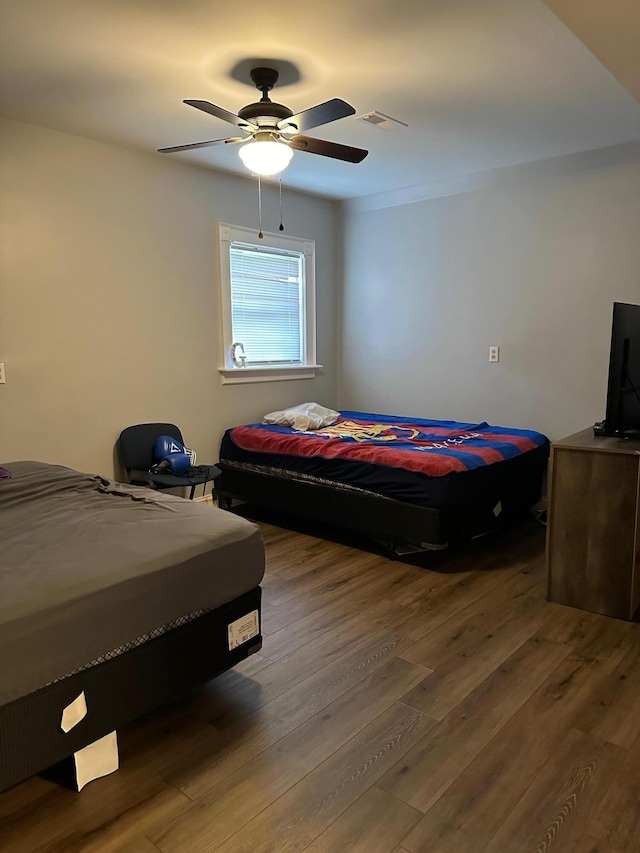 bedroom featuring hardwood / wood-style flooring and ceiling fan