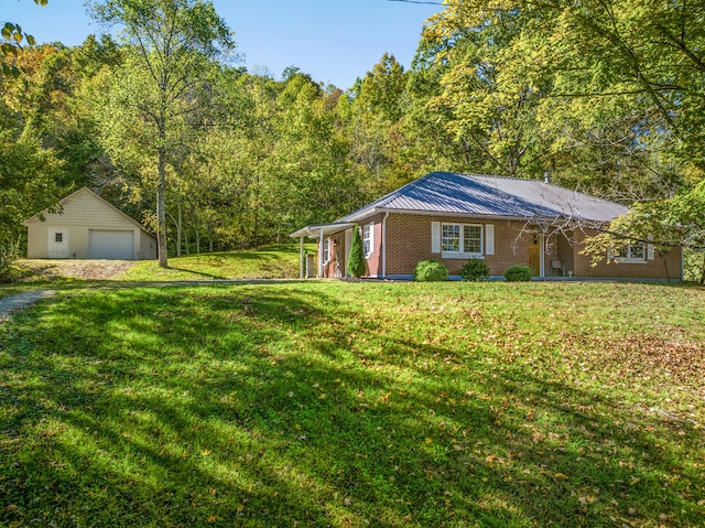 view of front of house featuring an outbuilding, a front yard, and a garage