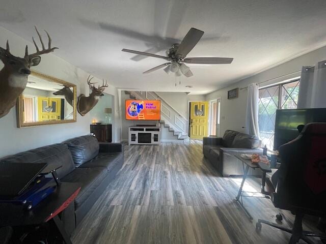 living room featuring ceiling fan and hardwood / wood-style flooring