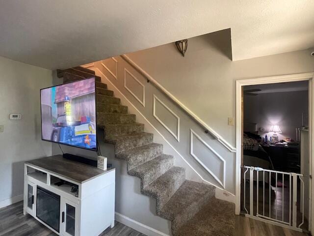 staircase with wood-type flooring