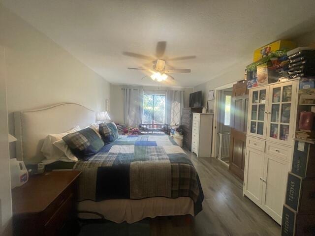 bedroom with dark wood-type flooring and ceiling fan