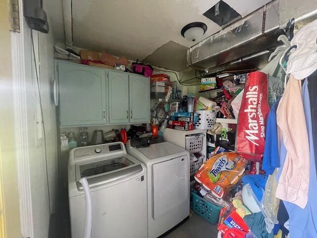 laundry area featuring cabinets and washing machine and dryer