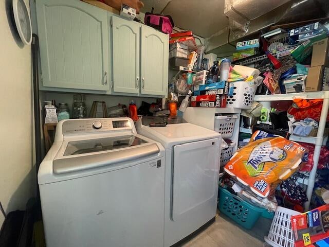 laundry area featuring independent washer and dryer and cabinets