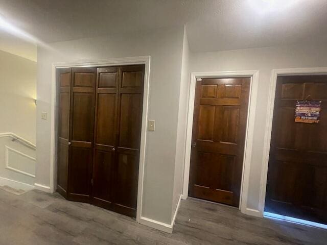 hallway with hardwood / wood-style flooring