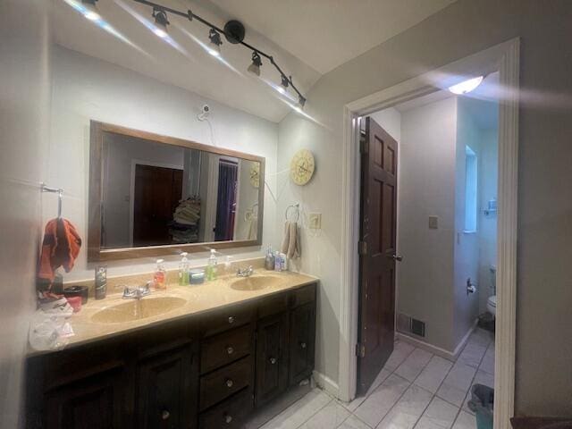 bathroom with vanity and toilet