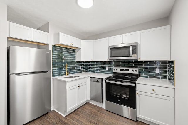 kitchen with stainless steel appliances, dark wood-type flooring, and white cabinetry