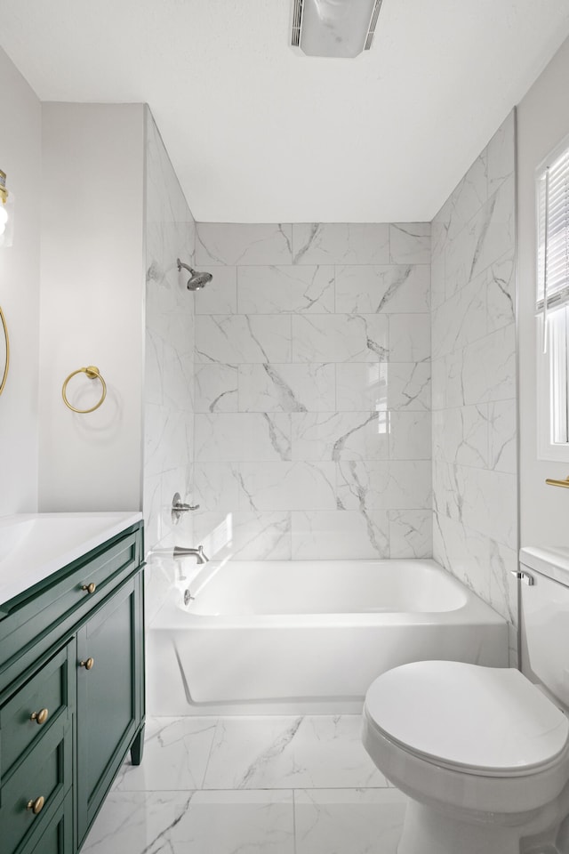 full bathroom featuring tiled shower / bath combo, vanity, and toilet