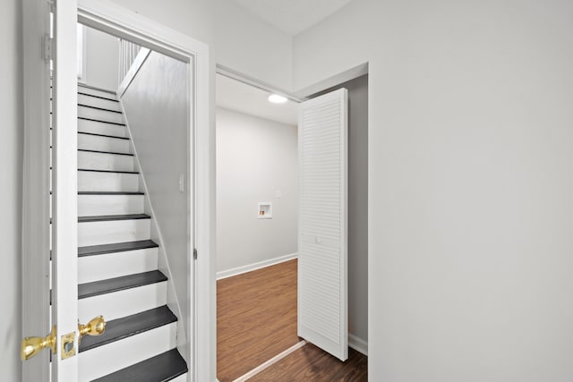 stairs featuring hardwood / wood-style floors