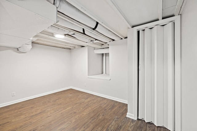 basement featuring dark hardwood / wood-style flooring