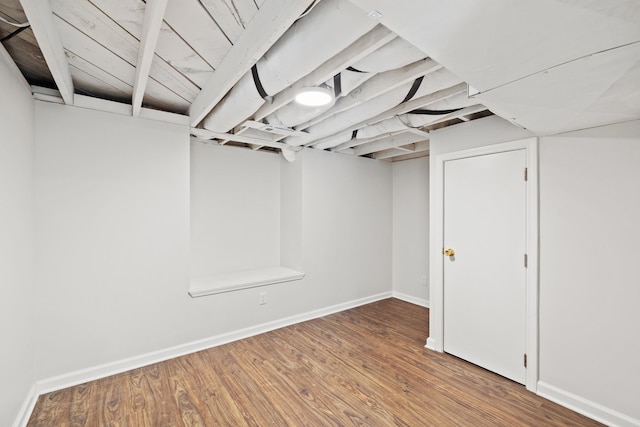 basement featuring wood-type flooring