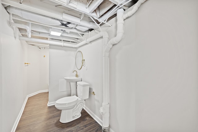 bathroom with hardwood / wood-style floors and toilet