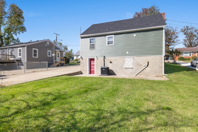 rear view of property with a yard and a deck