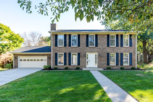 colonial-style house featuring a garage and a front lawn