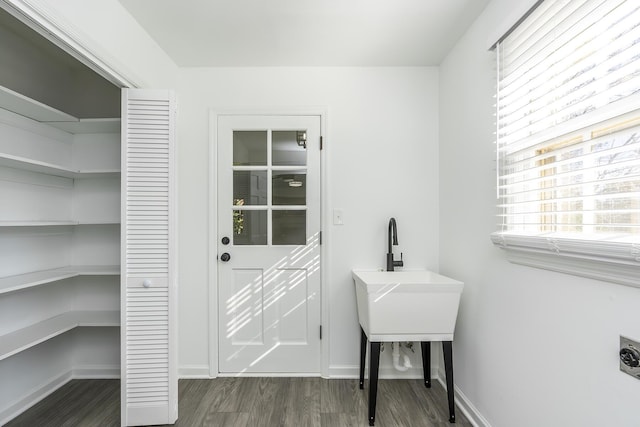 laundry room with dark wood-type flooring, laundry area, baseboards, and hookup for an electric dryer