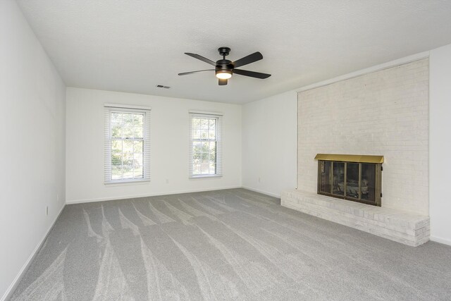 unfurnished living room featuring a fireplace, baseboards, ceiling fan, and carpet