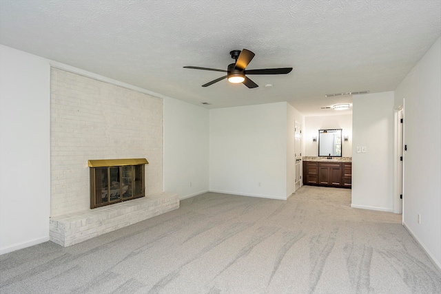 unfurnished living room featuring a fireplace, ceiling fan, and light carpet