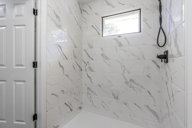 full bath with a tile shower