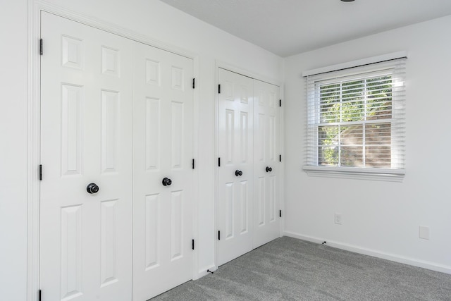 interior space featuring carpet flooring and baseboards