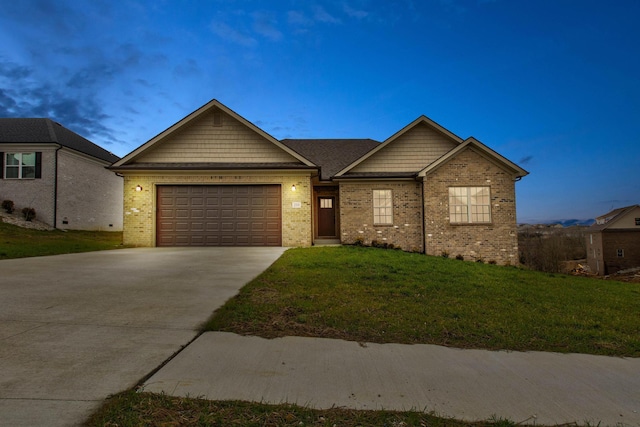 view of front of property with a garage and a lawn