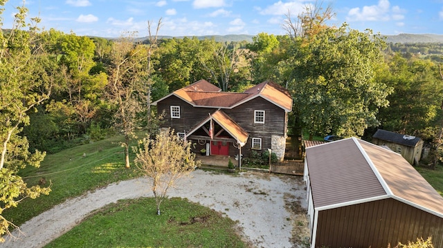 view of front of home with a front lawn, a mountain view, and covered porch