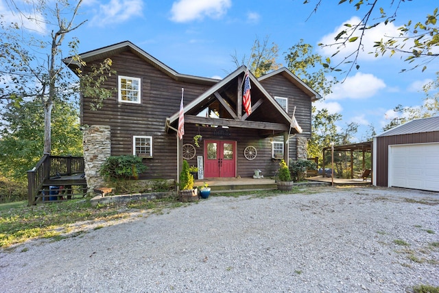 view of front of home with a deck and a garage