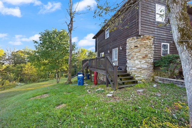 view of side of property with a deck and a yard