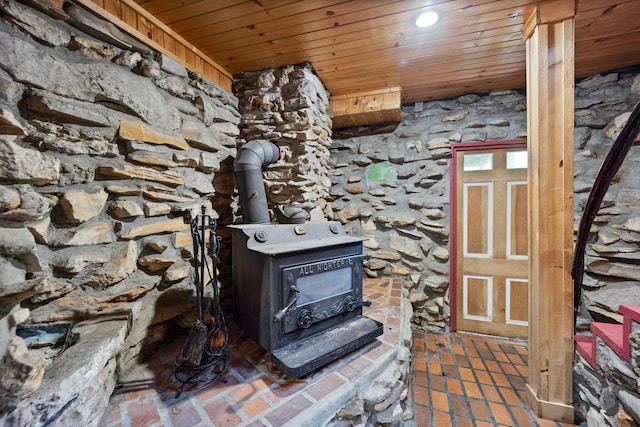 details featuring wood ceiling and a wood stove