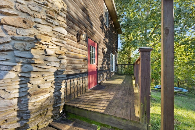 wooden terrace with a trampoline