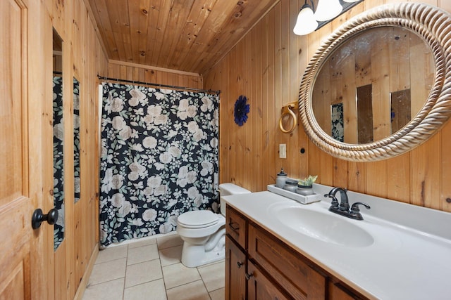 bathroom featuring wood walls, tile patterned floors, vanity, and toilet